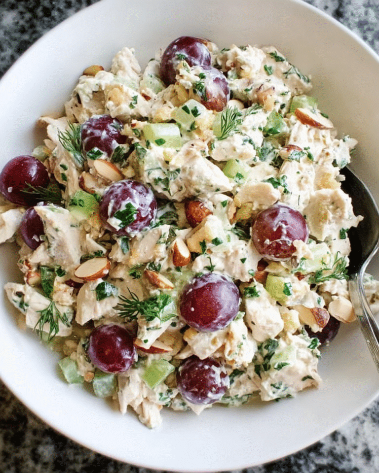Chicken salad with grapes and herbs in a rustic serving bowl