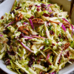 Apple Coleslaw with Cranberries and Pecans in fall setting