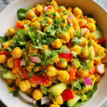 Curried Chickpea Salad in white bowl with fresh vegetables