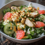 Tropical Kale Chicken Salad with Grapefruit Vinaigrette on ceramic plate