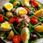 French salad with tuna on rustic plate