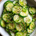 Asian Cucumber Sesame Salad served in bowl with garnishes