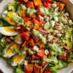 Chopped Green Goddess Salad in bowl with dressing