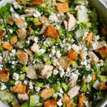 Chopped chicken salad with feta and lemon vinaigrette in bowl