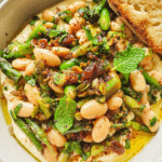 Mediterranean white bean salad in rustic bowl