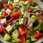 Mediterranean Greek Salad in ceramic bowl with fresh toppings