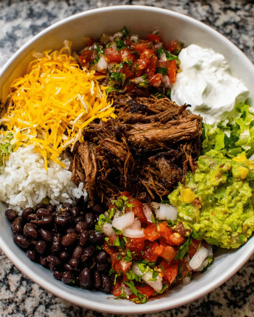 Shredded beef burrito bowl with toppings