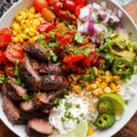 Overhead view of steak fajita bowl with colorful toppings