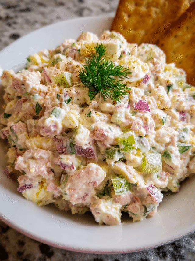 Creamy ham salad in rustic bowl with ingredients