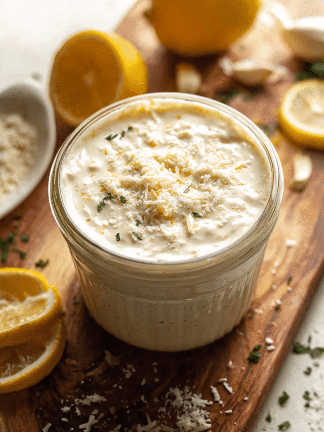 Homemade Caesar dressing in jar with fresh ingredients
