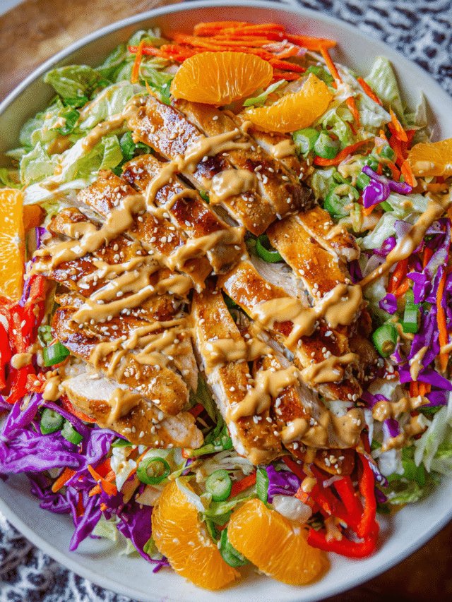 sesame orange chicken salad in white bowl