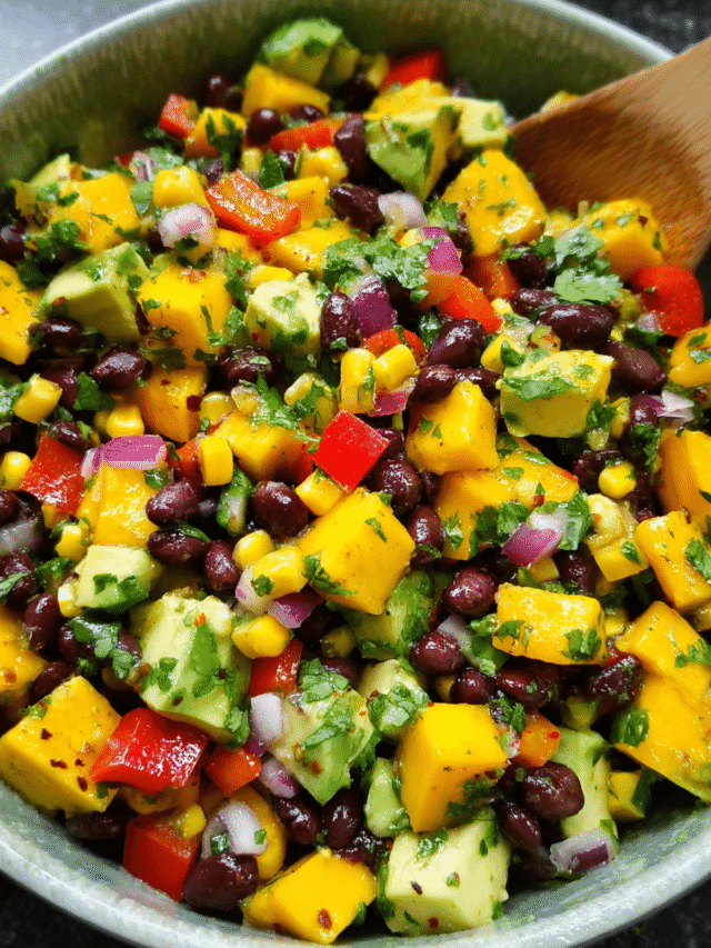 black bean mango and avocado salad in bowl with lime