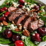 grilled steak salad with cherries in rustic bowl