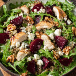 Arugula quinoa salad with chicken and beets in bowl