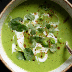Creamy spinach and pea soup in a bowl with garnish