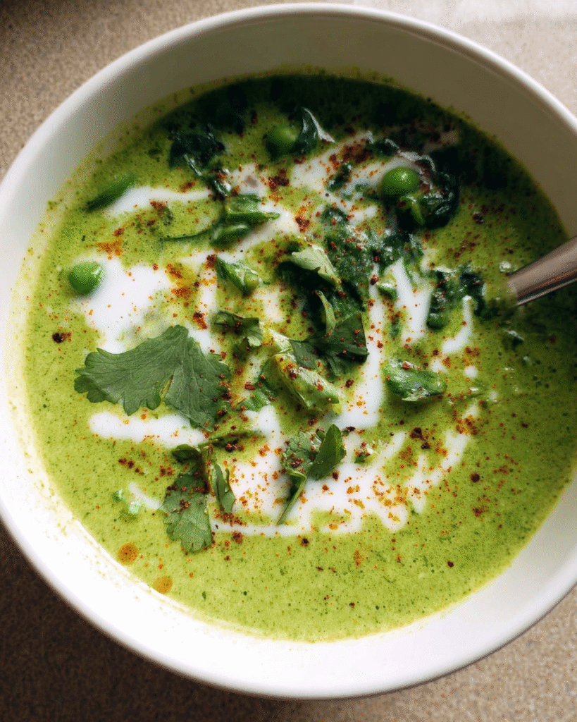 Creamy spinach and pea soup in a bowl with garnish