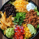 Taco salad meal prep in glass containers with fresh ingredients