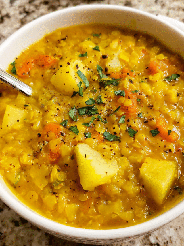 Bowl of creamy lentil potato soup with herbs