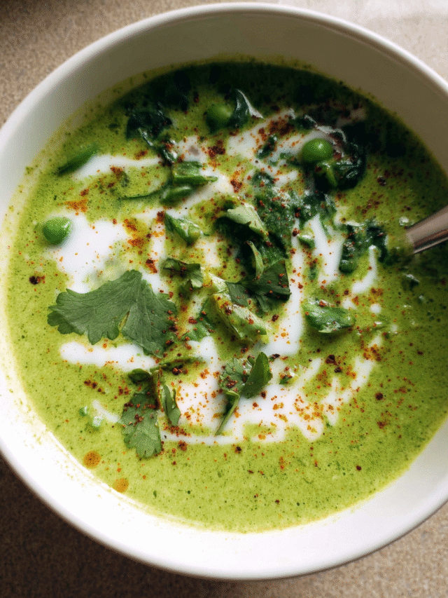 Creamy spinach and pea soup in a bowl with garnish