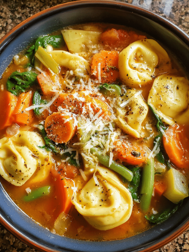 creamy vegetable tortellini soup in rustic bowl