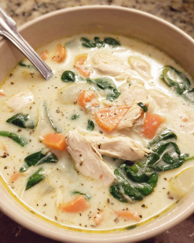 Creamy Chicken Florentine Soup in a bowl with spinach and Parmesan