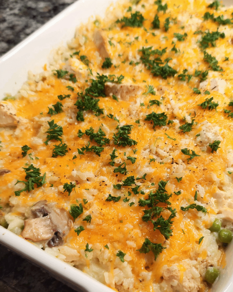 Creamy baked chicken and rice casserole with cheddar topping