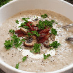 Creamy Mushroom and Leek Soup in a bowl with fresh parsley garnish