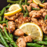 Lemon garlic chicken with green beans cooked in a skillet