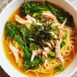 Bowl of Miso Ginger Chicken Soup with noodles, broccolini, and mushrooms