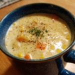 Bowl of creamy Parmesan Corn Chowder with vegetables