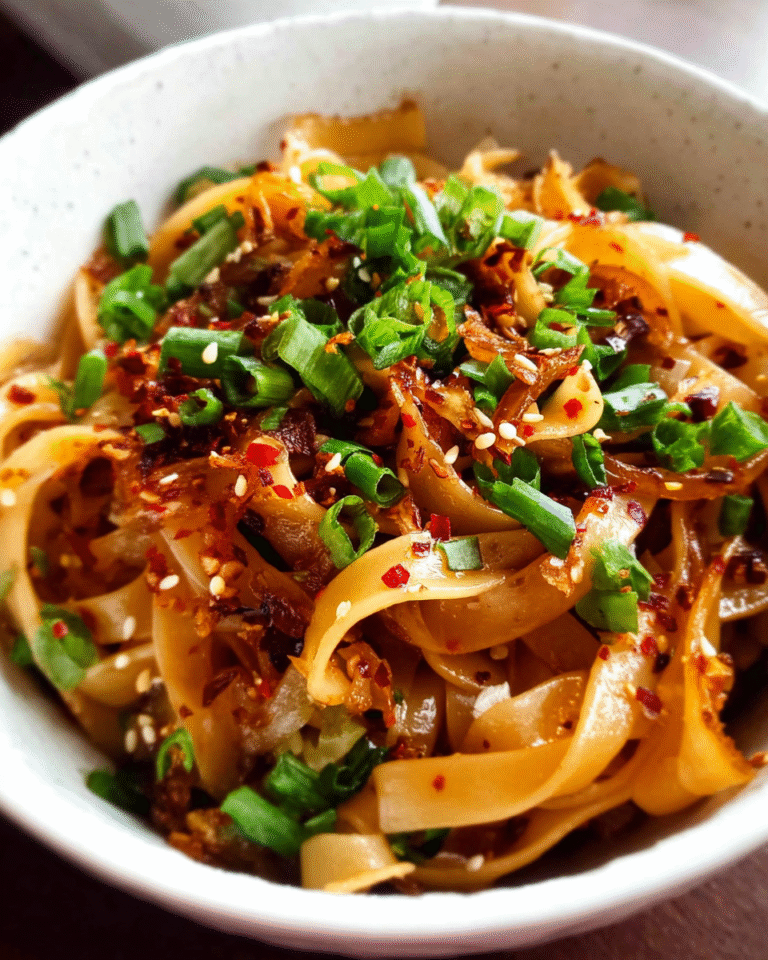bowl of spicy chili garlic noodles with green onions