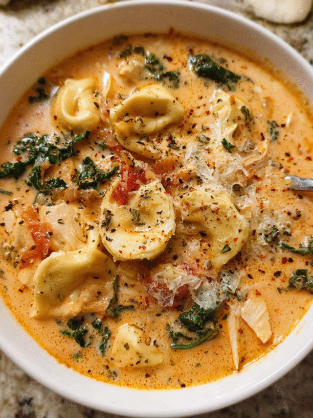 Bowl of creamy chicken tortellini soup with greens and parmesan
