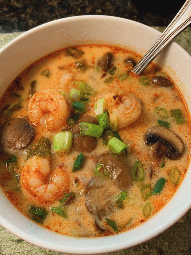 Bowl of coconut lemongrass shrimp soup with herbs