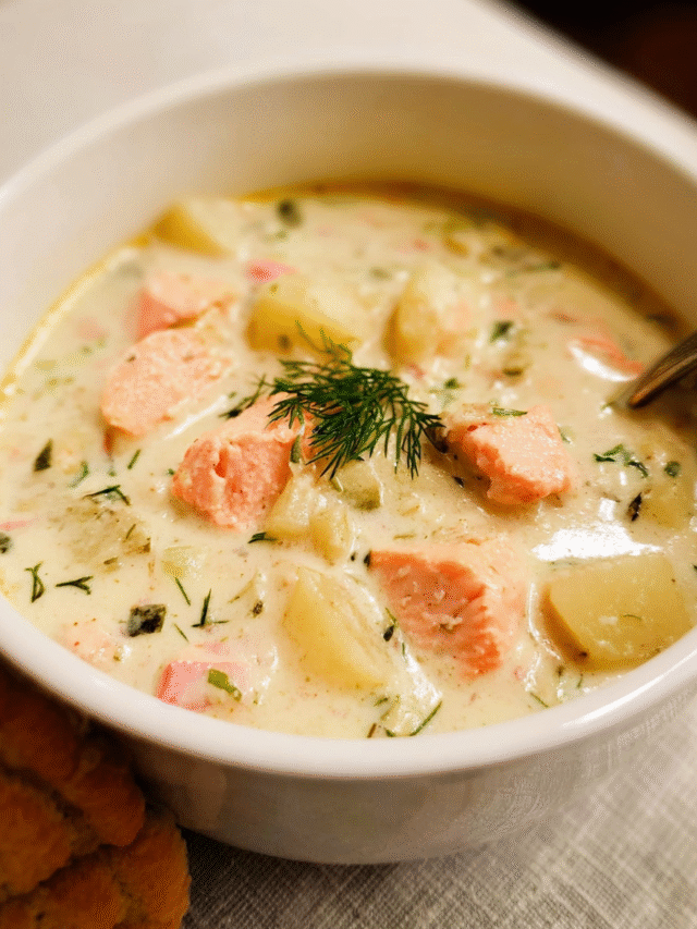 Creamy salmon chowder in a rustic bowl with potatoes and herbs