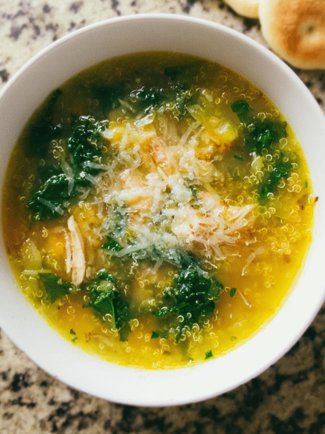 Bowl of kale quinoa chicken soup with lemon and parmesan