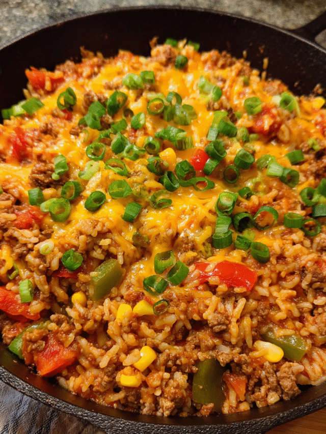 One-Pot Beef Taco Rice cooked in a skillet with cheese and green onions