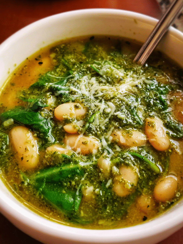 Spinach White Bean Pesto Soup in a bowl with Parmesan topping