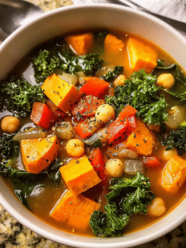 Sweet Potato Kale Soup in a bowl with chickpeas and fresh kale
