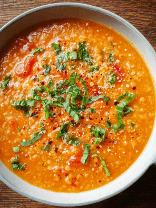 Creamy tomato lentil soup in a bowl with fresh basil