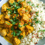 Creamy coconut curry chicken served over cauliflower rice