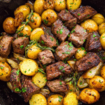Garlic butter steak and potatoes cooked in a skillet