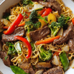 Meal Prep Beef and Veggie Stir-Fry Noodles in a skillet with colorful vegetables and noodles