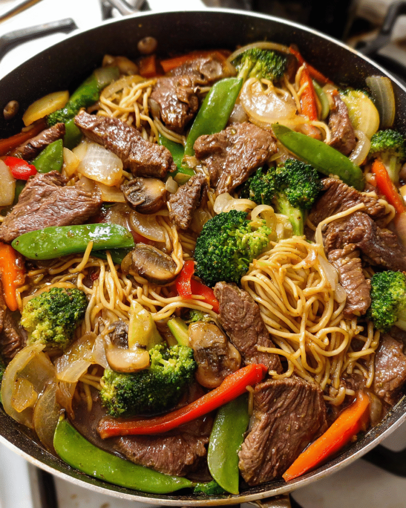 Meal Prep Beef and Veggie Stir-Fry Noodles in a skillet with colorful vegetables and noodles