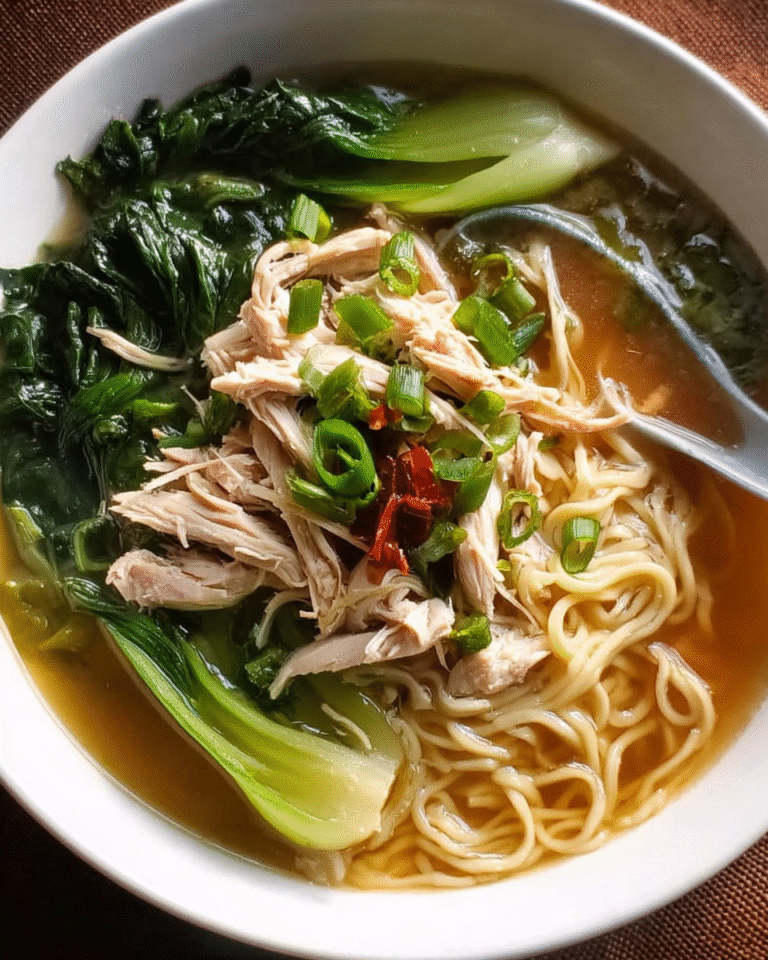 Asian noodle soup with chicken, bok choy, and fresh noodles in a bowl