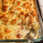 Baked creamy gnocchi in a casserole dish with melted golden cheese