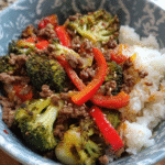Beef and vegetable rice bowl with ground beef, broccoli, and bell peppers over brown rice