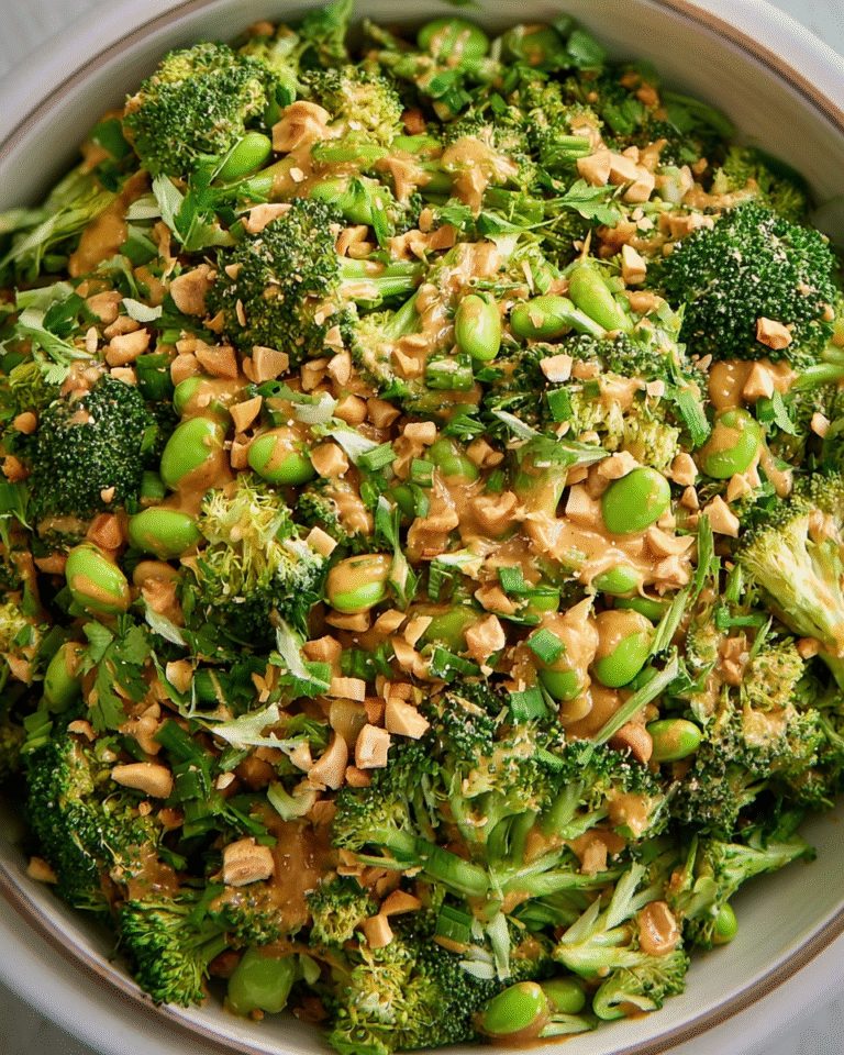 Broccoli Salad with Peanut Sauce in a bowl topped with roasted peanuts and cilantro