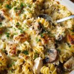 Creamy Chicken Alfredo Pasta baked with golden melted cheese and parsley