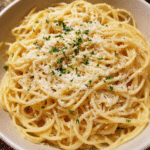 Garlic Parmesan Pasta served in a bowl with grated Parmesan