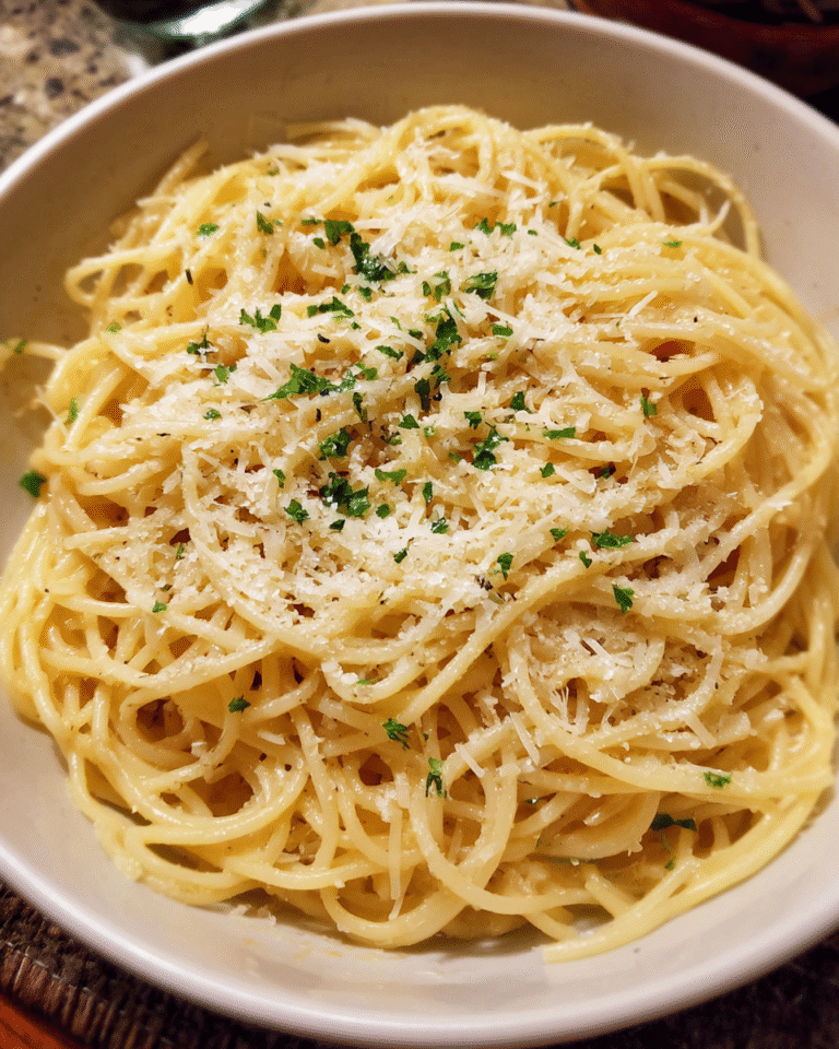 Garlic Parmesan Pasta served in a bowl with grated Parmesan